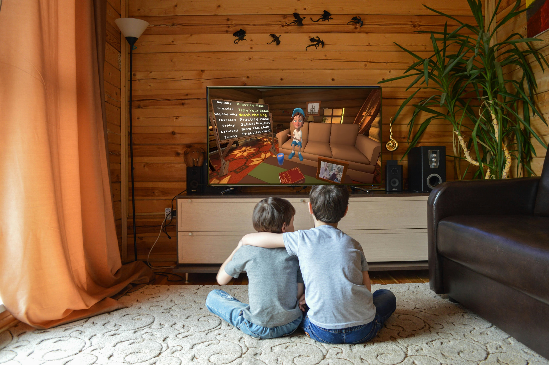 Two children watch Chuck the Elf present the weekly task board on their television